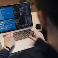 Man working on computer. Young it worker using laptop in the office, Internet marketing, technology, finance, business concept